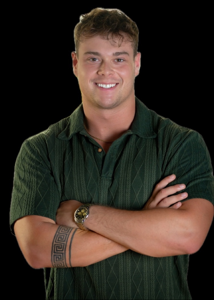 Ashby Henning, arms crossed, in a dark green knit polo